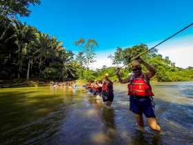 The first obstacle to cave tubing is getting across the Caves Branch River in Belize